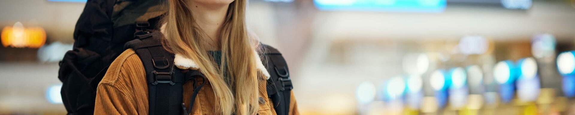 Mujer mochilera en el aeropuerto lista para su viaje